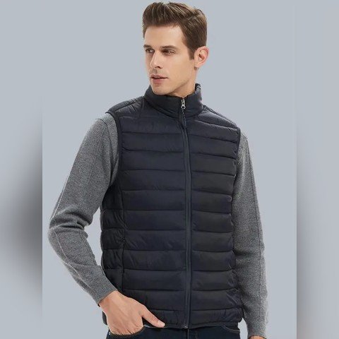 Man wearing a black padded gilet over a grey top
