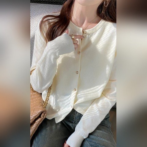 Woman wearing a cream button-front knit cardigan