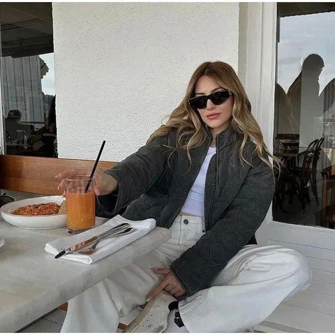 Woman wearing a grey quilted high neck jacket